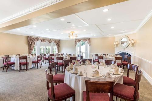 a banquet room with tables and chairs and a fireplace at Traditions Hotel & Spa, Ascend Hotel Collection in Johnson City