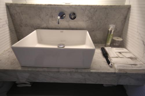 a white sink on a counter in a bathroom at Bestie Hotel in Busan