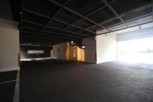 an empty parking lot with a large door in a building at Bestie Hotel in Busan