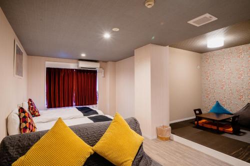 a bedroom with a bed and a couch and a window at Hotel Pagoda in Nara