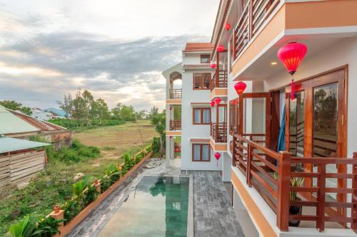 a view of a house with a pool and a balcony at Villa Loan A HOI AN in Hoi An