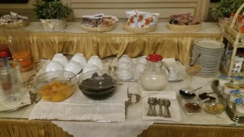 a table with a buffet with dishes and utensils at Hotel Antica Dogana in Turin