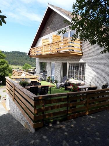 a house with a wooden deck on top of it at Gretel von Birne in Winterberg
