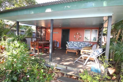 a covered patio with a table and chairs at Signal Cottage in Cowan Cowan