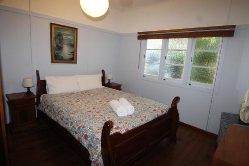 a bedroom with a bed with two towels on it at Signal Cottage in Cowan Cowan