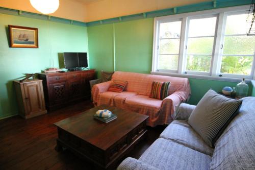 a living room with two couches and a coffee table at Signal Cottage in Cowan Cowan