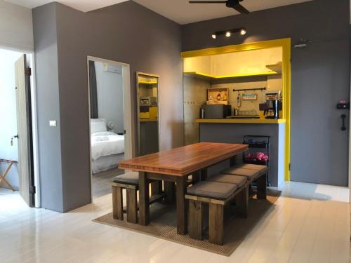 a dining room with a wooden table and benches at Chill Chill House in Shimen