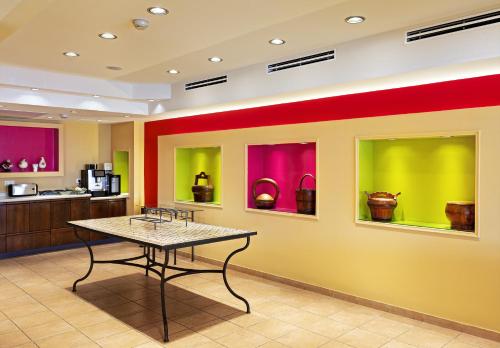 a room with colorful walls and a table in it at Mizpe Yam Boutique Hotel in Netanya