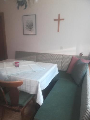 a small room with a table and a cross on the wall at Waldrast in Finkenberg