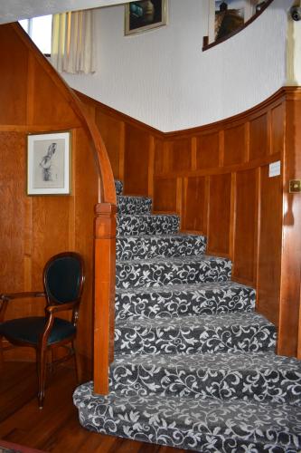 a stairway with a black and white carpet at Brae-Mar B&B in Portrush