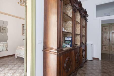 a large wooden cabinet in a room with a bedroom at Ca' de Capun in Manarola