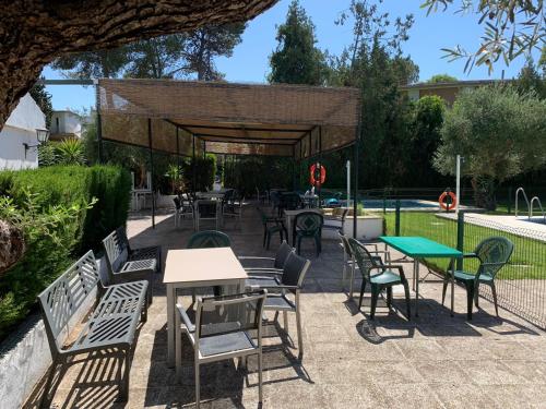 a patio with tables and chairs and a picnic shelter at El Balcón de Sevilla in Seville