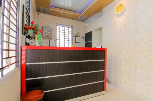 a red and black door in a room at Yani Homestay in Padang