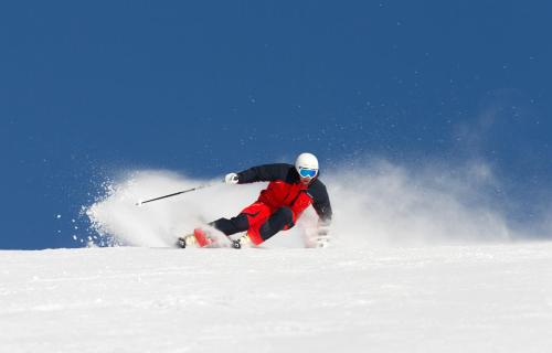 a person is skiing down a snow covered slope at Hovde Hotell in Vemdalsskalet