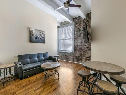 a living room with a couch and two tables at Gorgeous Condos - Walk to French Quarter in New Orleans
