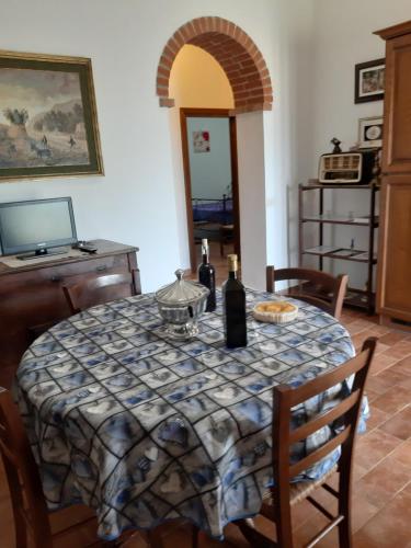 a table with two bottles of wine on top of it at Agriturismo Uliveto Gretacci in Montemerano