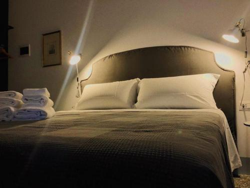 a bedroom with a large bed with two pillows at Torre Tresca 2 in Bari