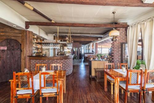 a restaurant with wooden tables and chairs and a bar at COLUMBUS Apartamenty Ustka - Limanowskiego 1 in Ustka