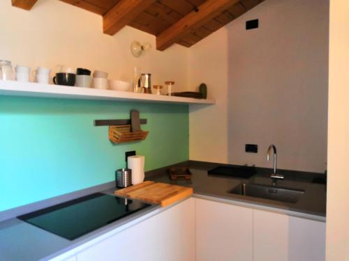 a kitchen with a sink and a counter top at BellaGiò Apartment pool free parking near lake in Bellagio