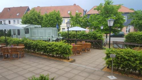 a patio with tables and chairs and a building at Hotel Stadt Boizenburg in Boizenburg
