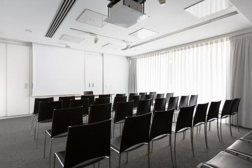 a conference room with black chairs and white walls at Aimia Hotel in Port de Soller