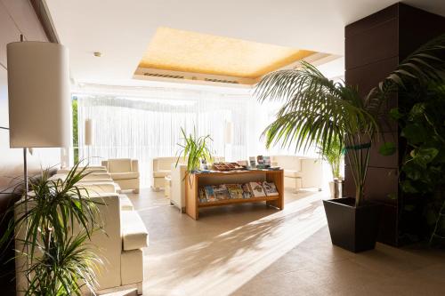 a living room with plants and a table at Aimia Hotel in Port de Soller