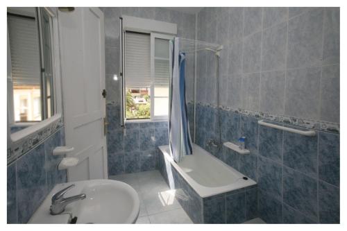 a bathroom with a sink and a toilet and a tub at Hostal Galicia in Ribadeo