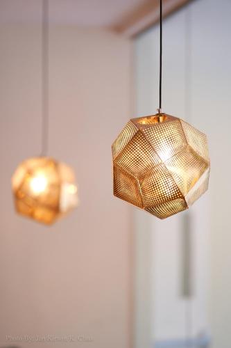 a close up of two lights hanging from a ceiling at Griffin Hotel and Suites in Cebu City