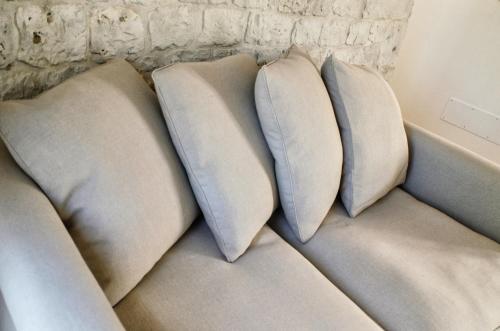 three pillows sitting on top of a couch at Borgo Santa Clara in Cisternino