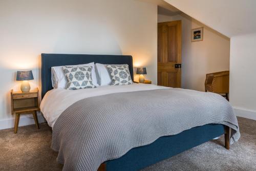 a bedroom with a large bed and two lamps at The Old School House B&B in Gairloch