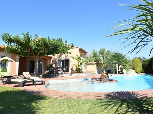 a swimming pool in a yard next to a house at Luxury holiday home with private pool in Rodilhan