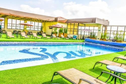 a pool at a hotel with chairs and tables at Verona Hotel and Conference Center in Ruiru