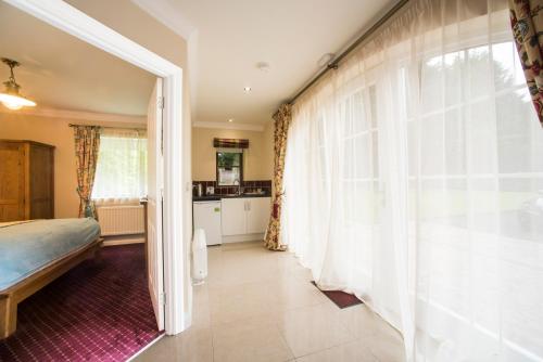 a bedroom with a bed and a large window at Oranmore in Ballymena