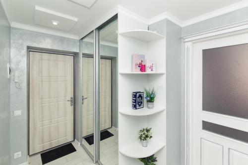 a bathroom with a shower and a glass door at Luxury apart-hotel on Kondrateva street in Sumy