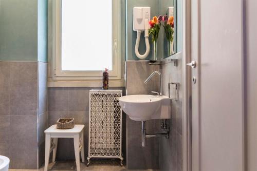 a bathroom with a sink and a flower vase at Dulcis In Vatican b&b in Rome
