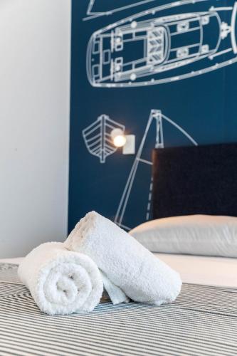 a pair of towels sitting on top of a bed at APARTMANI VIGO in Crikvenica
