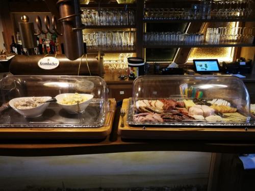 two trays of food on a counter in a restaurant at Hotel Restaurant Mühlenhof Bosse in Dachwig