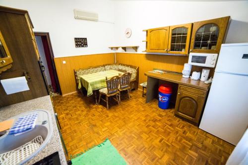 a kitchen with a table and a kitchen with a refrigerator at Apartments Vila Palma in Medulin