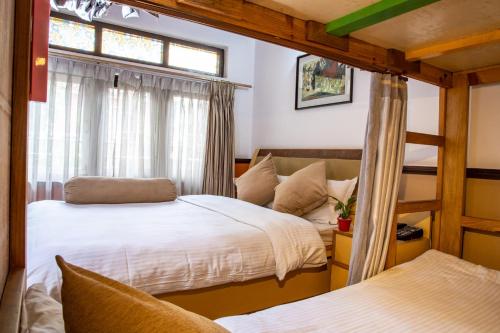 a bedroom with two beds and a window at Shangrila Boutique Hotel in Kathmandu