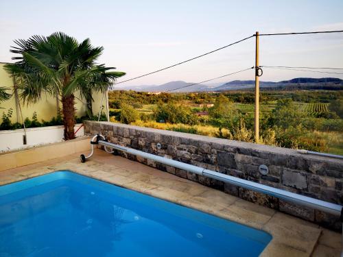 a swimming pool with a view of the mountains at Apartment Trieste HerMes arT in Sežana