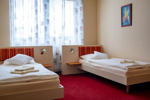 Postel nebo postele na pokoji v ubytování Penzion Na Kurtech