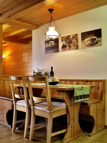 a dining room with a wooden table and chairs at Bergquelle 1.OG in Bettmeralp