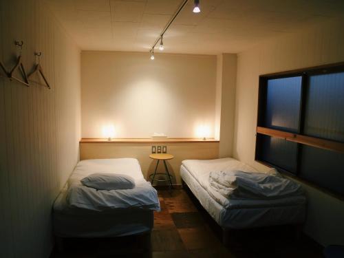 Кровать или кровати в номере Y Pub & Hostel Tottori