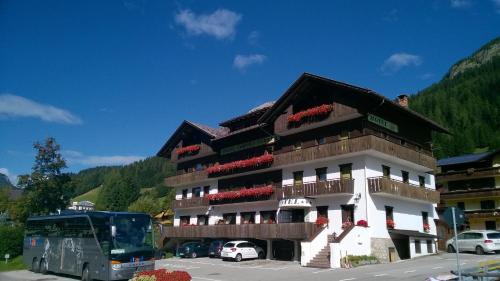 a bus parked in front of a building at Hotel Corona Ferrea in Sappada
