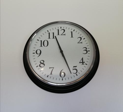 a clock is hanging on a wall at Lopes Apartment - Belch1952 in Lagos