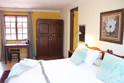 Een bed of bedden in een kamer bij Greenleaf Guest Lodge