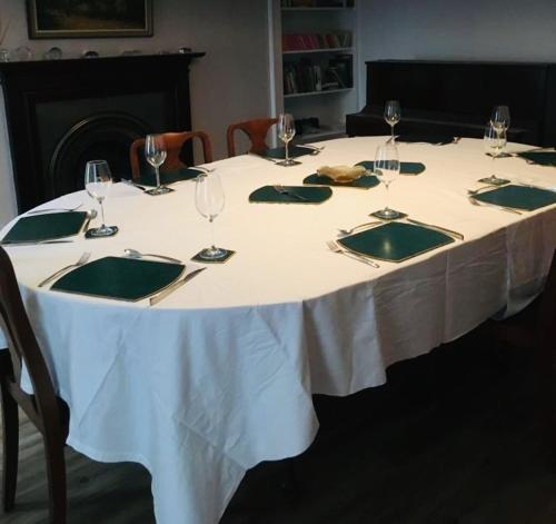 a white table with wine glasses and napkins on it at Springwells in Dunkeld