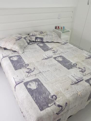 a bed with a blanket on it with scissors on it at Porto Real Resort in Mangaratiba