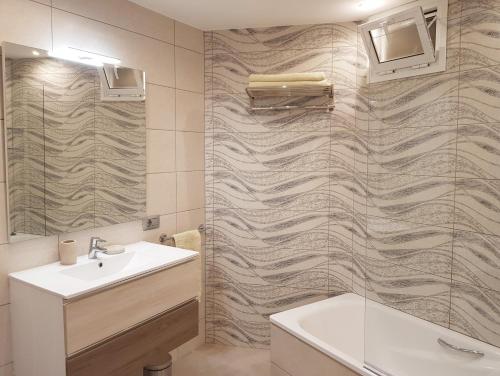 a bathroom with a sink and a shower at Beachfront Residence Las Americas - TRG in Playa de las Americas