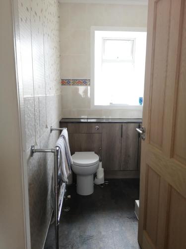 a bathroom with a toilet and a window at 27 Garenin in Carloway